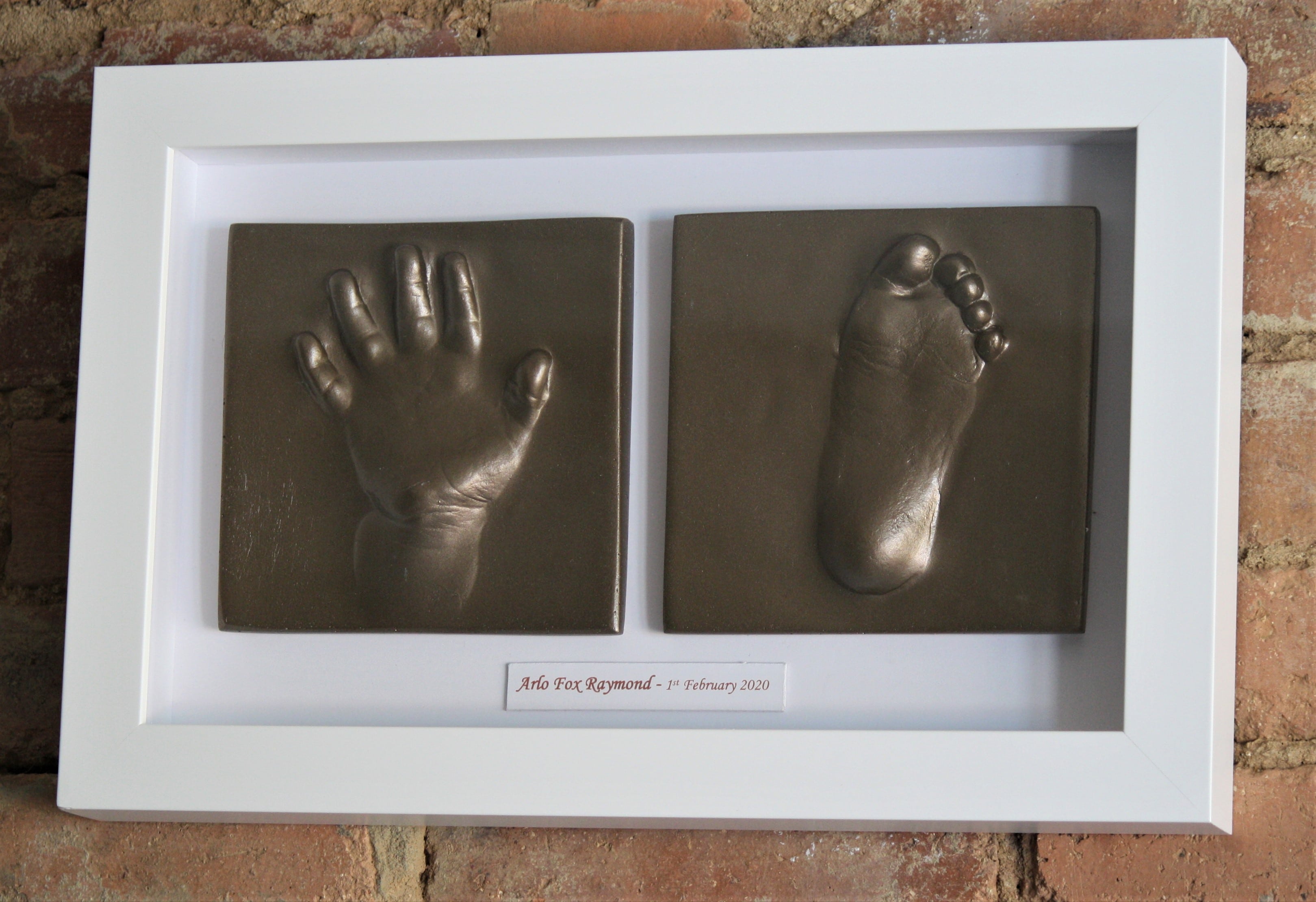 2d hand and foot impression tile of a toddler