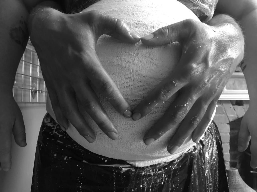 pregnancy belly bump casting with heart shaped hands