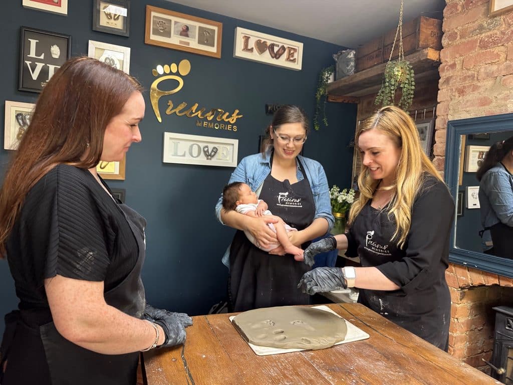 Students learning silver handprint jewellery and raised keepsake tiles at Precious Memories UK
