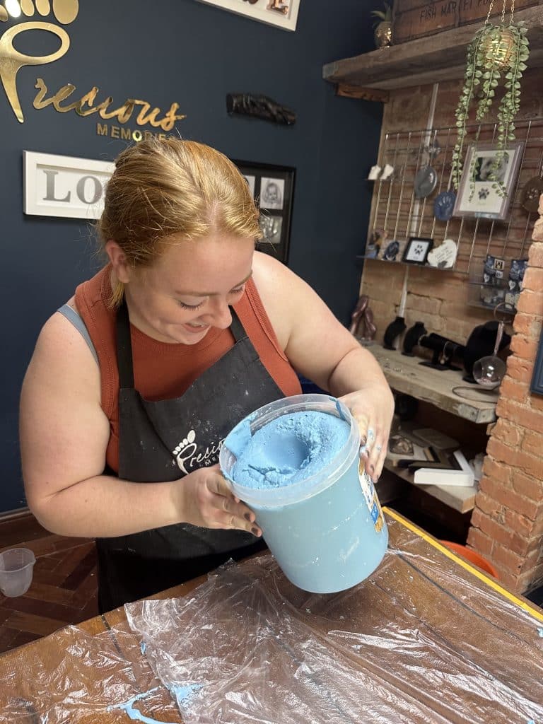 Student checking a handclasp mould before pouring plaster, life casting course
